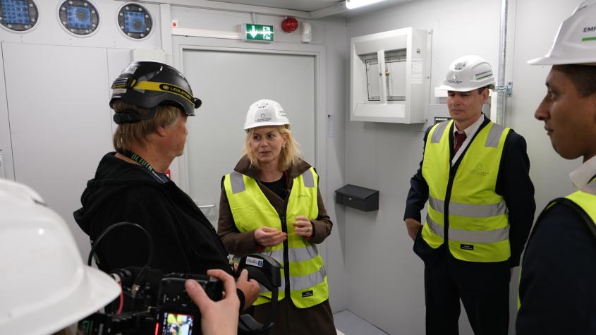 People inside a large data storage infrastructure container