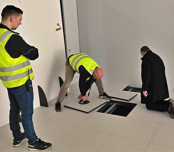 Workers who inspect a data centre floor.