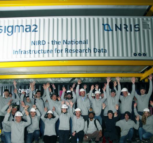 Several members of NRIS standing in front of one of the NIRD containers. 